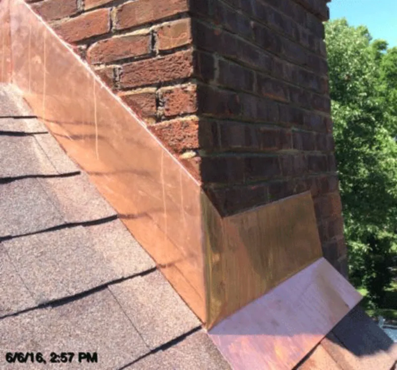 Copper chimney flashing installed by Barnhill Chimney with a stainless steel chase cover